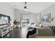 Bright living room with modern decor, dark wood floors, and sliding doors to the backyard at 1894 Valley Forge Dr, St Cloud, FL 34769