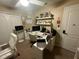 Bright home office featuring white desk, shelving and comfortable seating near a bright window at 1894 Valley Forge Dr, St Cloud, FL 34769