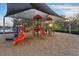 Community playground with colorful slides and climbing structures under a large canopy at 1894 Valley Forge Dr, St Cloud, FL 34769