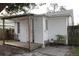 Rear exterior features a wood deck, a covered porch, and a white wood-sided structure at 1013 Illinois Ave, St Cloud, FL 34769