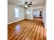 Open-concept living room with hardwood floors, a ceiling fan, and lots of natural light at 1013 Illinois Ave, St Cloud, FL 34769