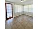 Bright sunroom featuring tile flooring and lots of natural light through multiple windows with blinds at 1013 Illinois Ave, St Cloud, FL 34769