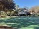 Community basketball court surrounded by mature trees and landscaping with recreation center in background at 10210 Hartford Maroon Rd, Orlando, FL 32827