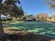 Community basketball court surrounded by mature trees, benches, and landscaping on a sunny day at 10210 Hartford Maroon Rd, Orlando, FL 32827