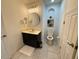 Stylish powder room with decorative mirror and convenient shelving at 10210 Hartford Maroon Rd, Orlando, FL 32827