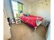 Bedroom with a metal bed frame, gray carpet, and a small nightstand at 10210 Hartford Maroon Rd, Orlando, FL 32827