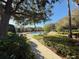 View of a community swimming pool with lounge chairs and lush landscaping in a serene environment at 10210 Hartford Maroon Rd, Orlando, FL 32827