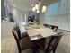 Dining area with a stylish chandelier and a view into the kitchen at 10210 Hartford Maroon Rd, Orlando, FL 32827