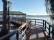 Community dock featuring a covered sitting area with views of the lake at 10210 Hartford Maroon Rd, Orlando, FL 32827