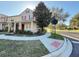 A beautiful townhome with red shutters and a front yard featuring a lovely tree at 10210 Hartford Maroon Rd, Orlando, FL 32827