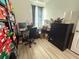 Office area with desk, black shelving, and a rolling black chair next to window with light filtering curtains at 10210 Hartford Maroon Rd, Orlando, FL 32827