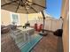 Back patio featuring a dining table with seating for six, and a large patio umbrella at 10210 Hartford Maroon Rd, Orlando, FL 32827