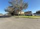 Exterior of a townhouse with a green lawn and street view of the neighborhood at 10210 Hartford Maroon Rd, Orlando, FL 32827