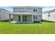 Spacious green lawn, covered porch, and two-story house in the background at 1111 Olivine Ave, Dundee, FL 33838