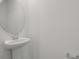 Half bathroom with pedestal sink, mirror and lighting at 1111 Olivine Ave, Dundee, FL 33838