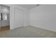 Bright bedroom featuring neutral carpet, closet, and view into an ensuite bathroom at 1111 Olivine Ave, Dundee, FL 33838