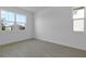 Clean, bright bedroom with neutral walls, tile floors, and large windows providing ample natural light at 1111 Olivine Ave, Dundee, FL 33838