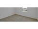 A bright bedroom with plush carpeting, white walls, and a large window at 1111 Olivine Ave, Dundee, FL 33838