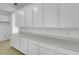 Modern kitchen featuring white cabinetry, quartz countertops, and stainless steel appliances at 1111 Olivine Ave, Dundee, FL 33838