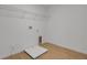 Clean, bright laundry room with wood-look flooring and washer/dryer hookups at 1111 Olivine Ave, Dundee, FL 33838