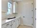 Functional mud room with ample cabinet space, a convenient countertop, and a bright window at 1111 Olivine Ave, Dundee, FL 33838