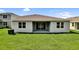 The home features a covered patio and sliding glass doors leading to a spacious backyard at 1115 Olivine Ave, Dundee, FL 33838