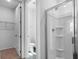 Elegant bathroom featuring glass-enclosed shower and a view to a closet and water closet at 1115 Olivine Ave, Dundee, FL 33838