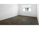 Cozy bedroom with wood-look tile flooring and a bright window at 1115 Olivine Ave, Dundee, FL 33838