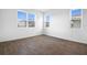 Bright bedroom with wood-look tile flooring and plenty of natural light at 1115 Olivine Ave, Dundee, FL 33838