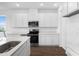 Bright kitchen with stainless steel microwave and stove, complemented by white cabinets at 1115 Olivine Ave, Dundee, FL 33838