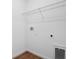 A laundry room with tile floors, washer hookups, and a wire rack for storage at 1115 Olivine Ave, Dundee, FL 33838