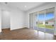 Spacious living area with sliding glass doors to the patio and wood-look tile flooring at 1115 Olivine Ave, Dundee, FL 33838
