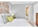 Comfortable bedroom featuring a white bed, decorative pillows, and unique wood slice art above the headboard at 1119 Olivine Ave, Dundee, FL 33838