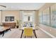 Dining room adjacent to the living area, features a modern table with seating and stylish decor at 1119 Olivine Ave, Dundee, FL 33838