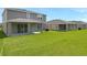 Expansive backyard displays modern homes with covered patios, lush lawns, and ample green space at 1127 Olivine Ave, Dundee, FL 33838