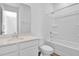 Bright bathroom featuring a tub with shower, single sink vanity, and modern fixtures at 1127 Olivine Ave, Dundee, FL 33838
