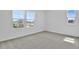 Neutral bedroom with carpet, windows, and ample natural light, perfect for relaxation at 1127 Olivine Ave, Dundee, FL 33838