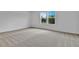 Bright bedroom with soft carpet and large windows offering a pleasant outdoor view at 1127 Olivine Ave, Dundee, FL 33838