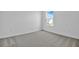 Cozy bedroom featuring soft carpeting, bright window, and a serene atmosphere at 1127 Olivine Ave, Dundee, FL 33838