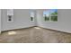 Sunlit bedroom with tile floors and multiple windows providing plenty of natural light at 1127 Olivine Ave, Dundee, FL 33838