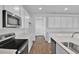 Modern kitchen featuring stainless steel appliances, white cabinets, and light countertops at 1127 Olivine Ave, Dundee, FL 33838