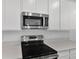 Modern kitchen featuring stainless steel microwave and stove and light countertops at 1127 Olivine Ave, Dundee, FL 33838