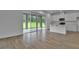 Open concept living space with tile floors and a view of the kitchen and outdoor patio at 1127 Olivine Ave, Dundee, FL 33838
