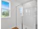 Modern walk-in shower with glass door, offering a luxurious bathroom experience at 1127 Olivine Ave, Dundee, FL 33838