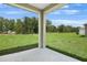 Covered patio provides great views to the yard beyond at 1131 Olivine Ave, Dundee, FL 33838