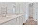 Bright bathroom features a double vanity with quartz countertop and a glass-enclosed shower at 1131 Olivine Ave, Dundee, FL 33838