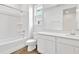 Clean, bright bathroom featuring a shower-tub combo, vanity with sink, and modern fixtures at 1131 Olivine Ave, Dundee, FL 33838