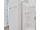 Shower with a glass enclosure, sleek fixtures, and convenient shelving at 1131 Olivine Ave, Dundee, FL 33838