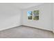 Bright bedroom has neutral carpet, a large window with natural light, and freshly painted walls at 1131 Olivine Ave, Dundee, FL 33838