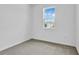 Cozy bedroom with neutral carpet, a large window with a view, and ample natural light at 1131 Olivine Ave, Dundee, FL 33838